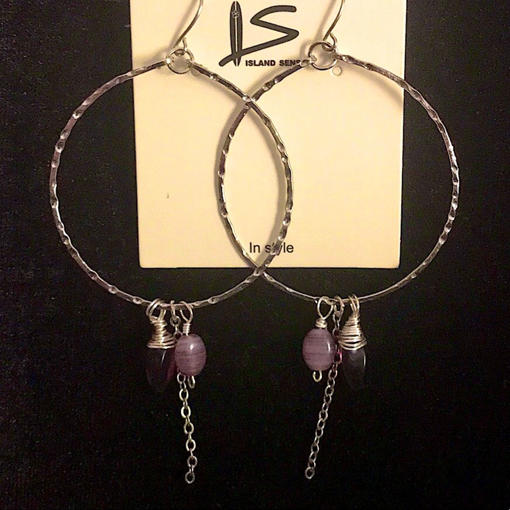 Silver hoop dangle earrings with purple stones.